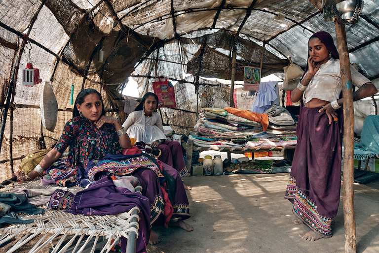 Charan huts, Gujarat.They are made of bent bamboo strips covered with fabric made from discarded jute gunny bags or twigs, supported by a pole in the center. These light structures used by these nomadic communities are easy to dismantle and transport in their wanderings.
